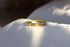 cute real gold mama ring with or without diamonds ♡ it makes a great unique gift for your mothers, for new mom, friends or for yourself with its cool and trendy look it will complete your everyday look ♡ material options: 10k gold   14k gold 14k rose gold 14k white gold 18k gold 18k rose gold 18k white gold For diamond option;  VS1 - VS2 diamond quality,  0.015 ct   shipping: ♡ all listings include free expedited shipping delivers in 2-4 business days care tips : we want you to wear your jewelry for a long long time happily so, to maintain the quality of your new jewelry, please: ♡ do not wear it to the pool, spa, or the beach  ♡ remove when sleeping, exercising, or doing other physically strenuous activities ♡ avoid contact with perfumes, body oils, and other chemicals, including househol Gold Engraved Ring For Mother's Day, Yellow Gold Engraved Ring For Anniversary On Mother's Day, Gold Stackable Rings For Anniversary And Mother's Day, Gold Stackable Rings For Anniversary On Mother's Day, Gold Custom Name Ring For Mother's Day, Gold Rings With Custom Name For Mother's Day, Custom Name Gold Rings For Mother's Day, Yellow Gold Stackable Rings For Anniversary And Mother's Day, Handmade Gold Ring For Mother's Day