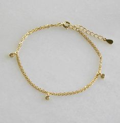 Our double chain gold bracelet will add a little sparkle to your wrist. Two strands of sparkling chain with dainty cz drops gives a minimal and chic touch for everyday. Makes the perfect gift too! Dainty jewelry designed for you to live in! D E T A I L S -Dainty link chain -Adorned with dainty cubic zirconia gold drops -High quality 14kt gold over sterling silver -Length is 6 inches with a 1 inch extender for a total length up to 7 inches. ∙ EXTRA LOVE ∙ Crafted and curated just for you in the d Gold Adjustable Chain Bracelet For Friendship, Dainty Gold Chain Bracelet For Friendship, Gold Double Chain Bracelet For Party, Gold Delicate Chain Bracelet For Friendship, Double Gold Chain, Gold Chain Bracelets, Large Gift Boxes, Dainty Bracelet, Chain Bracelets