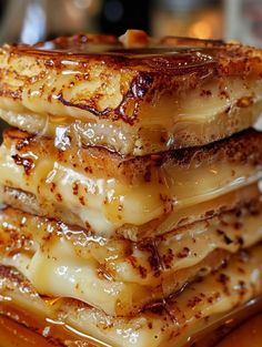 a stack of bananas sitting on top of a wooden cutting board covered in honey syrup