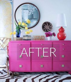 a pink dresser with the words after painted on it in front of a mirror and flowers