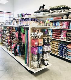 a store with shelves filled with clothing and shoes