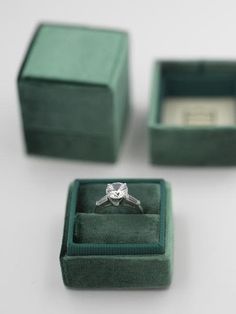 an engagement ring in a green velvet box