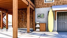 a yellow surfboard sitting on top of a wooden porch next to a gray door