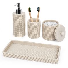 bathroom accessories including soap dispenser, toothbrush holder and toilet paper roll