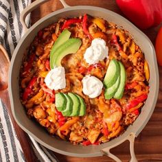 a casserole dish with meat, cheese and avocado