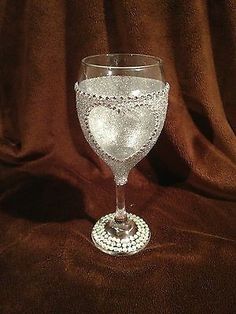 a wine glass sitting on top of a brown cloth