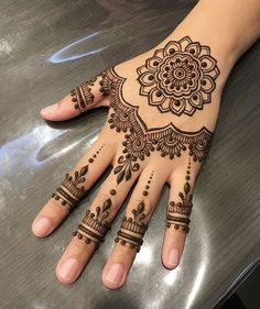 a henna tattoo is on someone's hand