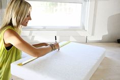 a woman is writing on a piece of paper