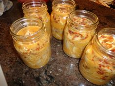 several jars filled with food sitting on top of a counter