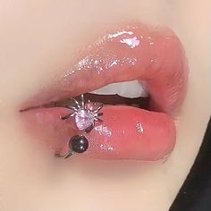 a close up of a person's tongue with a spider ring on top of it