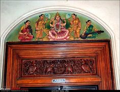 an ornate wooden door with paintings on it