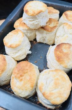 a pan filled with biscuits sitting on top of a wooden table