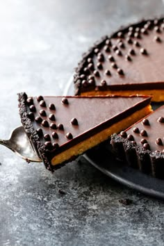 a piece of chocolate cake on a plate with a spoon