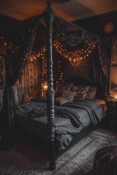 a canopy bed with lights hanging from it's sides in a dark colored room