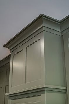 a kitchen with green cabinets and white walls