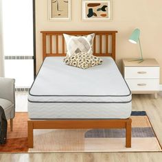 a bed with a wooden headboard and foot board