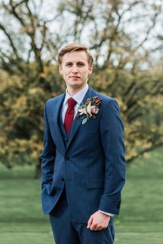 a man in a blue suit and red tie