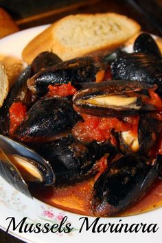 mussels in marinara sauce with bread on the side