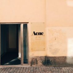 an open door with the word acne written on it is in front of a building