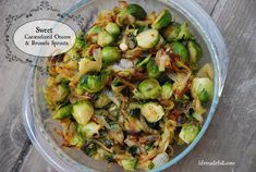 a glass bowl filled with brussel sprouts and onions