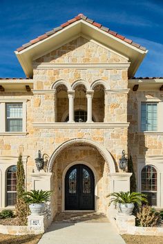 the front entrance to a large home with columns and arches on it's sides