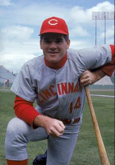 a baseball player poses with his bat on the field