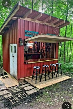 an outdoor bar with stools in front of it