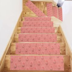 the carpeted stairs are lined with pink dots