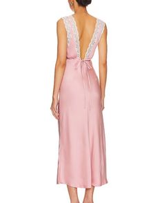 Step into enchantment with the Lovers and Friends Jordan Midi Dress in Baby Pink. With its satin and lace trim, soft-girl style has never looked more chic. Elevate your elegance now. Self: 100% polyester Trim: 100% nylon Made in China Dry clean only Unlined Hidden back zipper and tie closure Lightweight satin fabric with lace trim