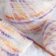 two skeins of yarn sitting next to each other on top of a table