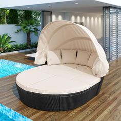 an outdoor day bed next to a swimming pool