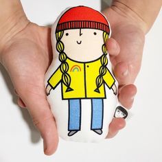 a person holding a small stuffed animal in their hands