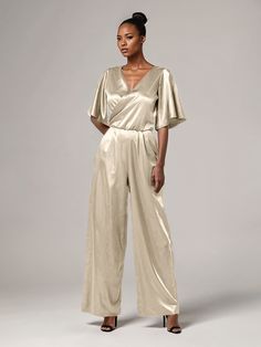 This soft satin jumpsuit features a flattering v-neck design, making it the perfect choice for mothers of the bride. Its dress pantsuit style provides comfort and elegance, while its high-quality material ensures a polished look. Stay stylish and comfortable on that special day with our jumpsuit. Dress Pantsuit, Bride Jumpsuit, Elegant Jumpsuit, Dress Pant Suit, Satin Jumpsuit, Jumpsuit Elegant, Peacock Green, Mother Of The Bride Dress, Dress With Tie