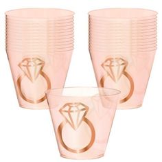 a set of pink plastic cups with a diamond on the side