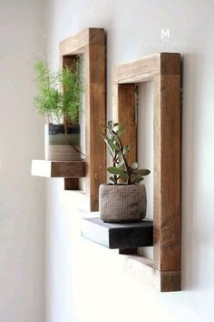 three wooden shelves with plants and potted plants on them, hanging from the wall