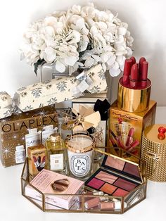 the contents of an assortment of beauty products are displayed in front of a vase with flowers