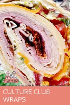 a sandwich wrapped in tin foil with meat, cheese and other toppings on it