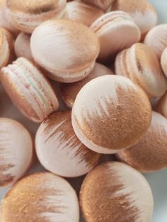 macaroons are sitting on a white plate with gold flecks around them