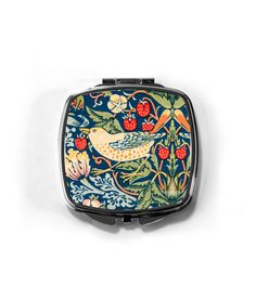 a small compact case with birds and flowers on it's sides, against a white background