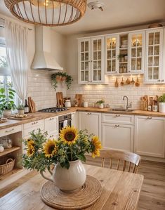 a kitchen with sunflowers in a vase on the table