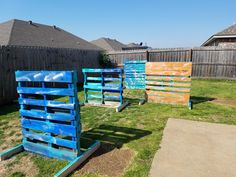 three wooden pallets sitting in the grass