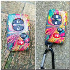 a cell phone that is sitting on the ground next to a lanyard keychain