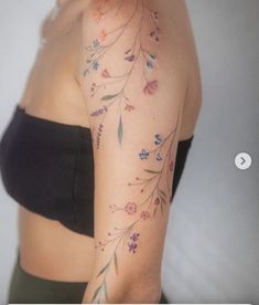 a woman's arm with flowers on it