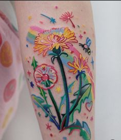 a colorful flower tattoo on the leg