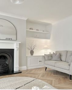 a living room filled with furniture and a fire place