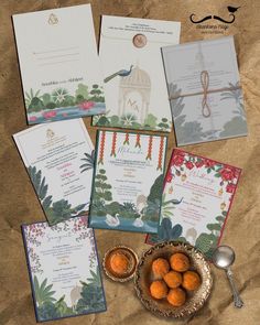 the wedding stationery is laid out on top of brown paper with oranges and silverware