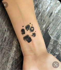 a person with a paw print on their wrist and foot in the middle of it