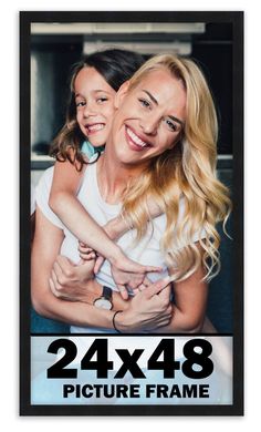 a woman holding a child in her arms with the words 24x38 picture frame