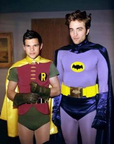 two young men dressed in costumes standing next to each other, one wearing a batman costume