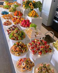 a buffet line with many different types of food on plates and trays lined up